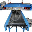 Self-cleaning magnet situated above the conveyor